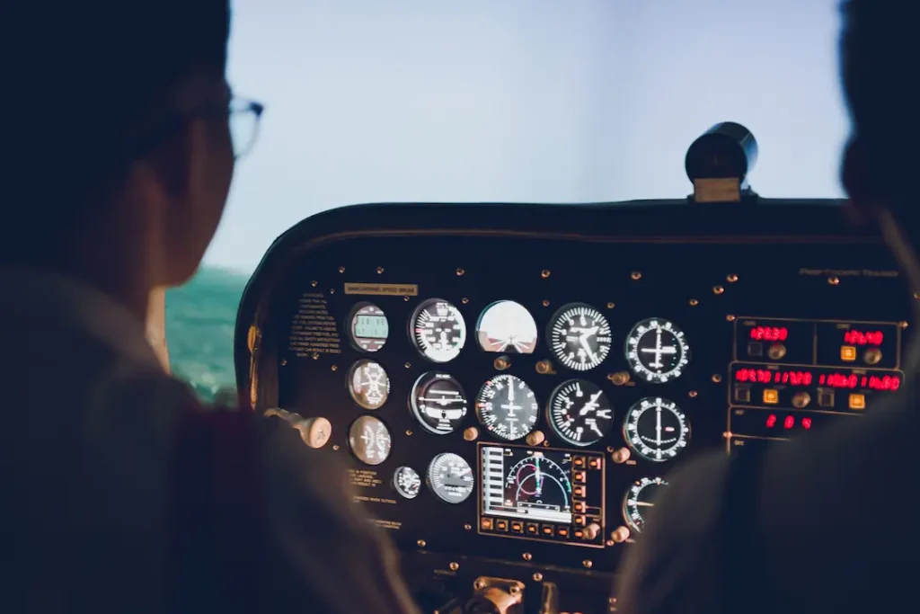 Student pilot in light aircraft cockpit reviewing instrument panel during Private Pilot Licence training in Canada.